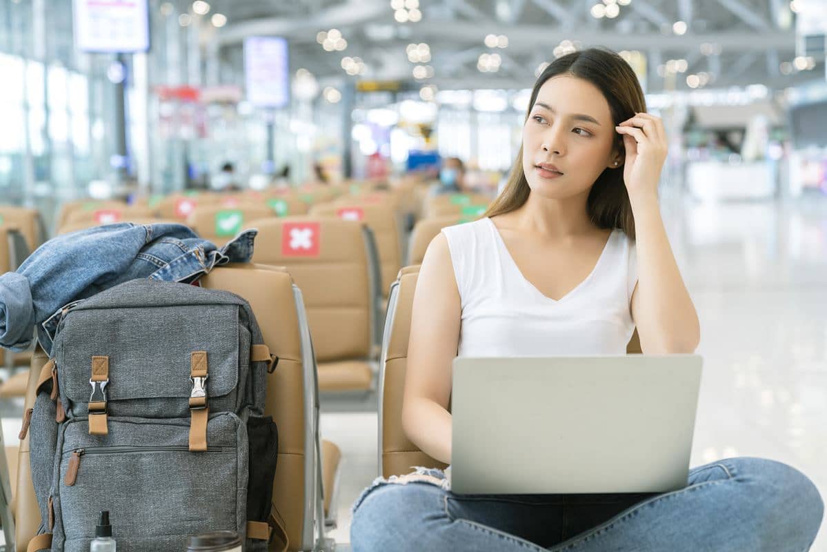 Women booking flight online at airport